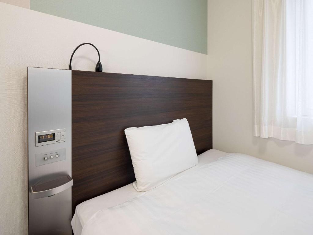 Postel nebo postele na pokoji v ubytování Comfort Hotel Kure