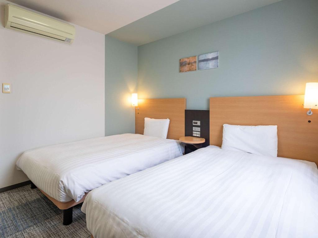 Postel nebo postele na pokoji v ubytování Comfort Hotel Kure