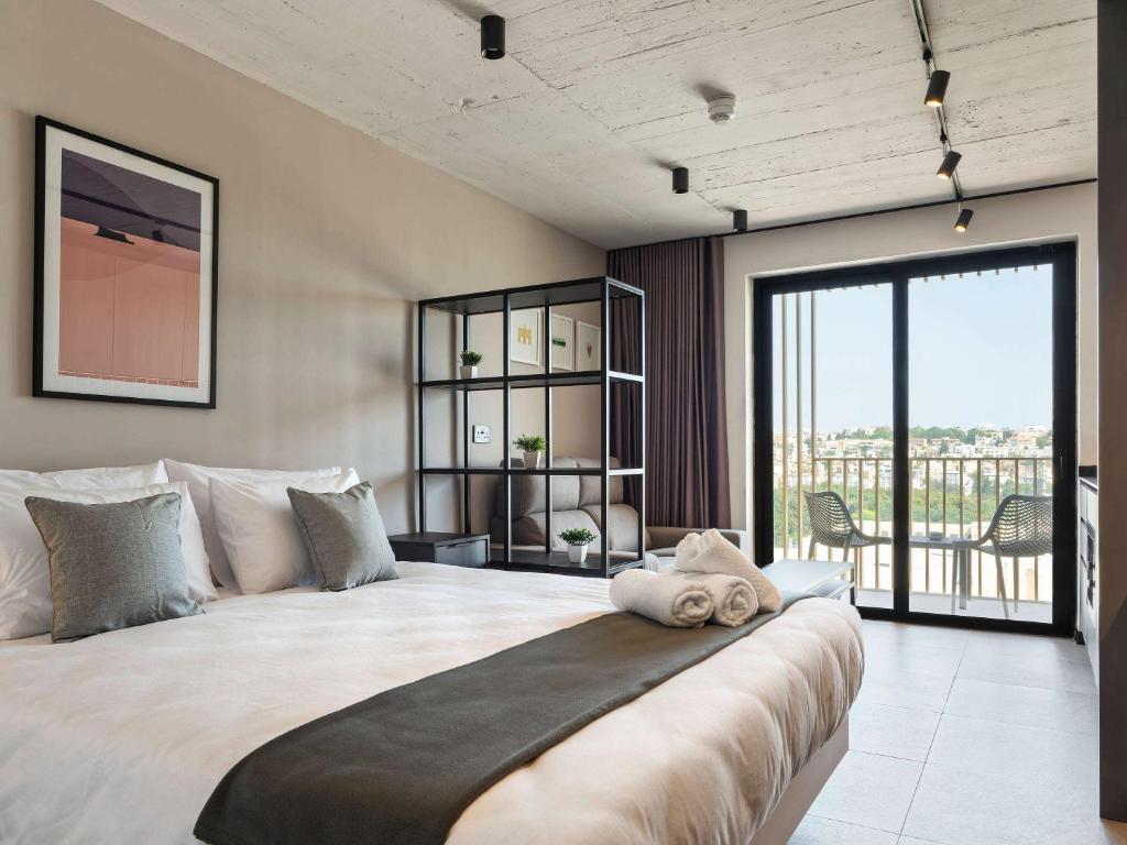 Postel nebo postele na pokoji v ubytování Aparthotel Adagio Malta Central