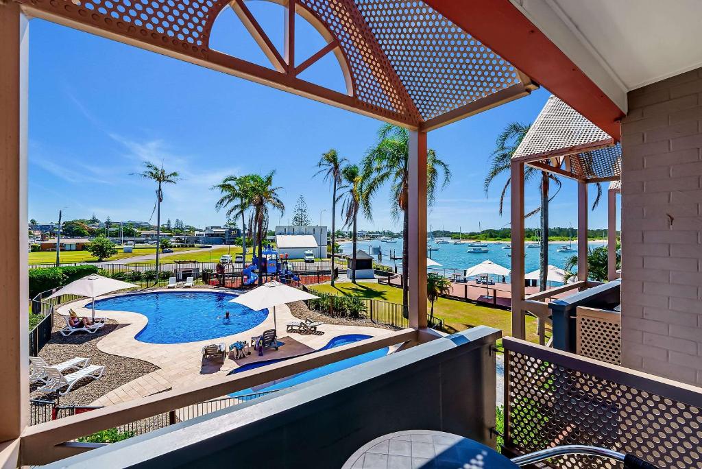 a view of the pool from the balcony of a resort at Comfort Resort Waters Edge in Port Macquarie