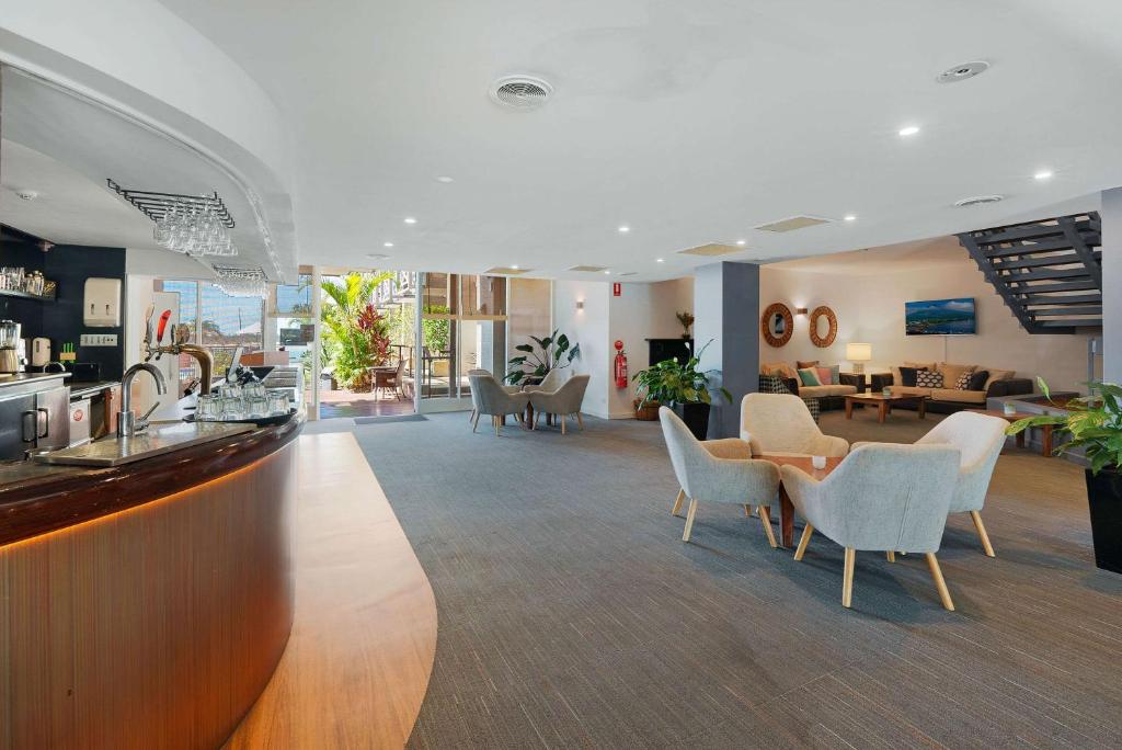 a lobby with chairs and a bar in a hotel at Comfort Resort Waters Edge in Port Macquarie