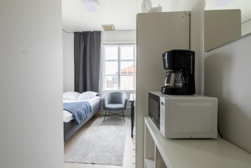 a small bedroom with a bed and a window at City Premium huone Vanha Postitalo in Varkaus