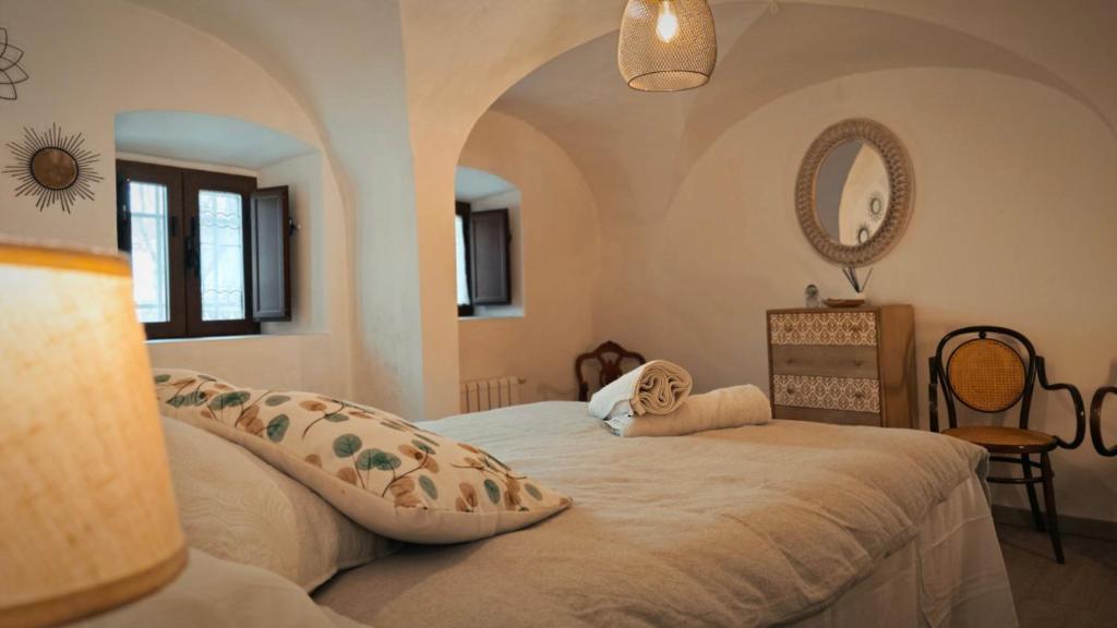 a bedroom with a bed in a room with a mirror at Casa Filo - Country house near la Cruz de Piedra in Plasenzuela