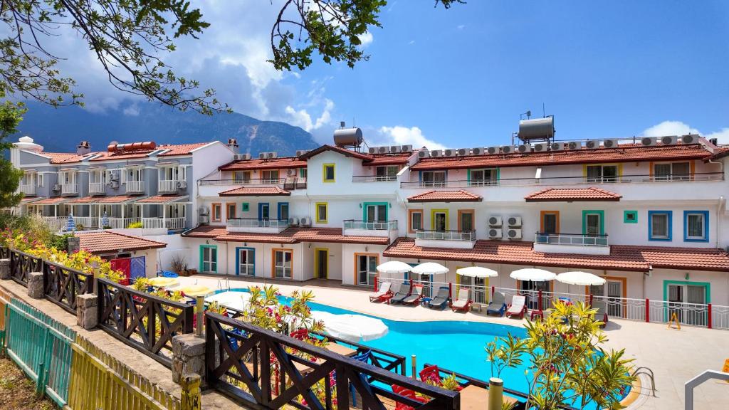 a hotel with a swimming pool and buildings at Konfor Suite Otel in Oludeniz