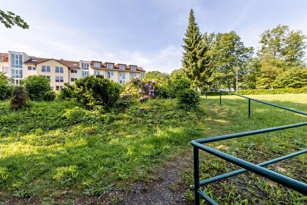 een uitzicht op een gebouw met een hek bij Aparthotel am Stadtpark in Bad Sachsa