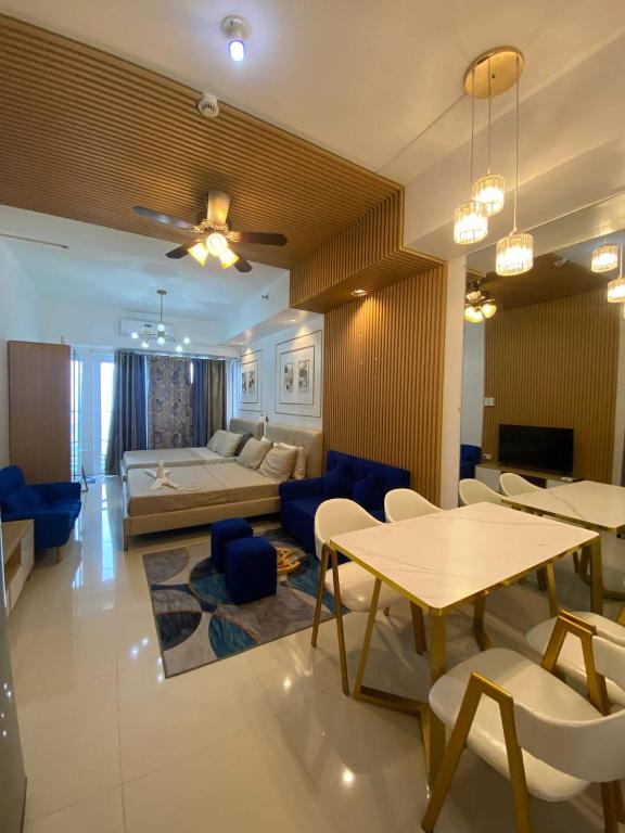 a living room with a couch and a table and chairs at D Luckycharm staycation in Tagaytay