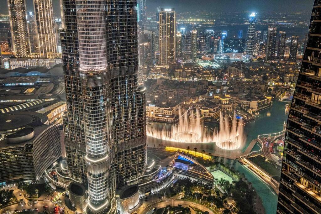 Hotel Luxe 3BR Retreat, Balcony Burj & Fountain Views, Prime Downtown Stay, an aerial view of a city at night at Luxe 3BR Retreat, Balcony Burj & Fountain Views, Prime Downtown Stay in Dubai