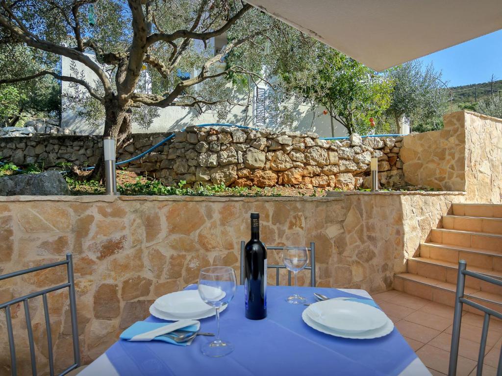 a blue table with a bottle of wine on it at Apartment Cico-2 by Interhome in Gdinj