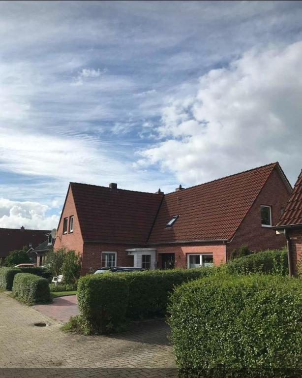 a large brick house with a brown roof at Ferienhaus Ronny in Hinte