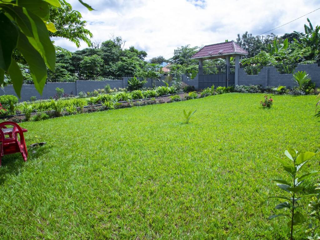a lawn with a gazebo in a yard at Aminata Homes & Apartment in Moshi
