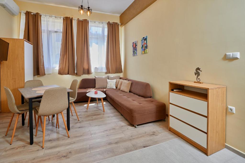 a living room with a couch and a table at Peneka Hotel in Pomorie