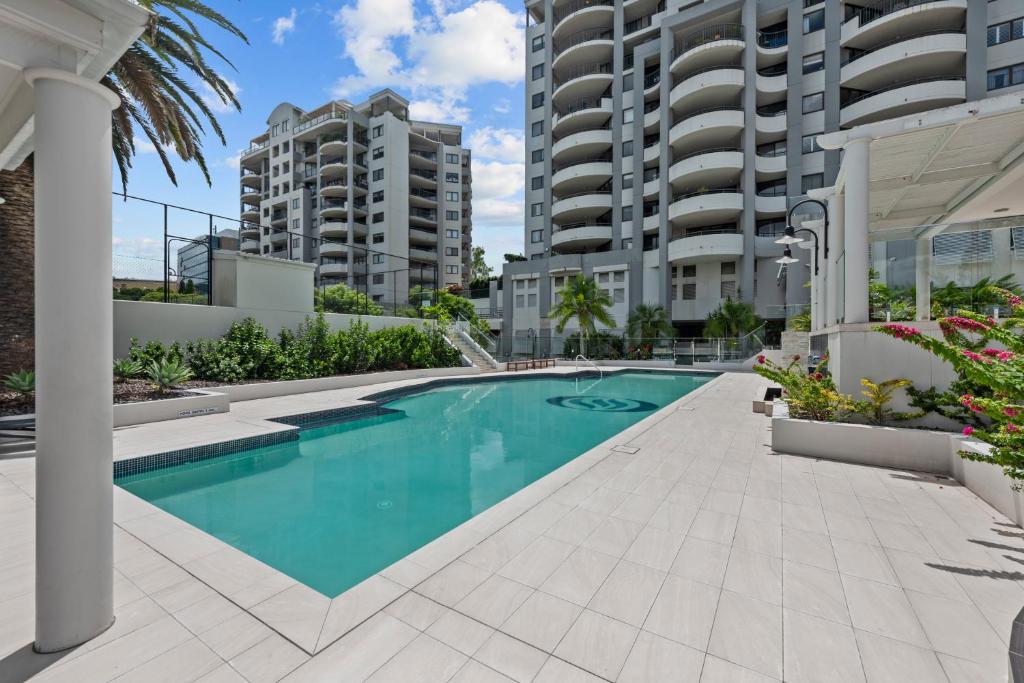 a swimming pool in front of some apartment buildings at The Oasis Apartments in Brisbane