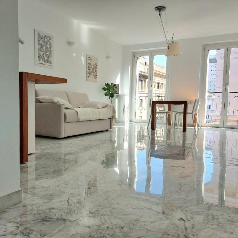 a living room with a couch and a table at Ducale interno 5 in Genova