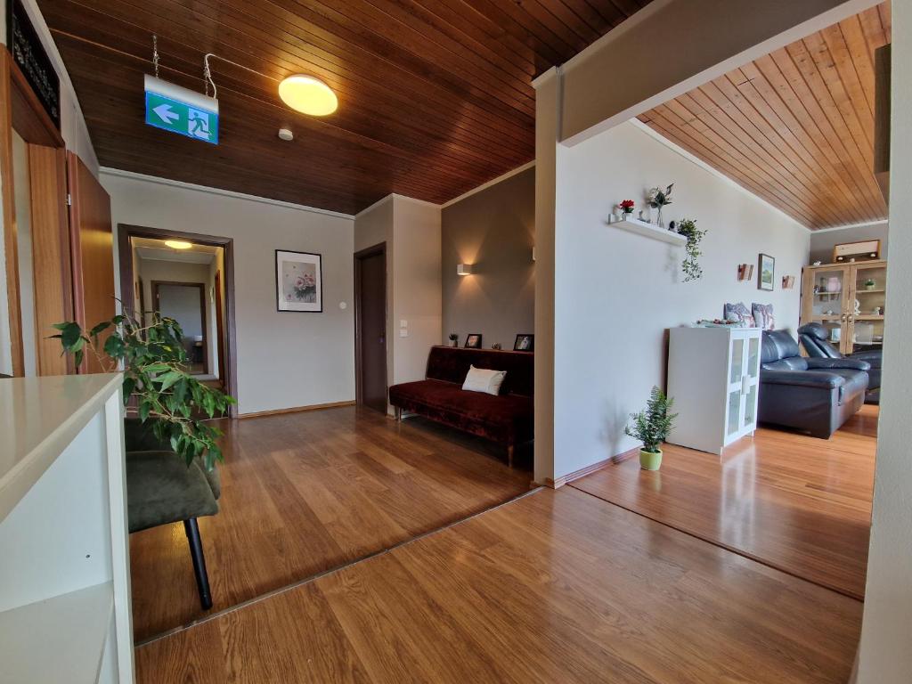 a living room with a wooden ceiling at Helgafell Guesthouse in Stykkishólmur