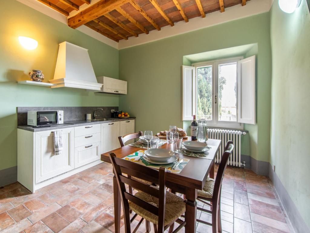 a kitchen with a table and chairs in a room at Apartment Antico Duomo-4 by Interhome in Cortona