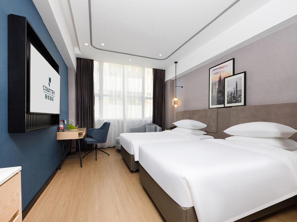 Postel nebo postele na pokoji v ubytování Country Inn & Suites by Radisson Shenzhen International Convention and Exhibition Center