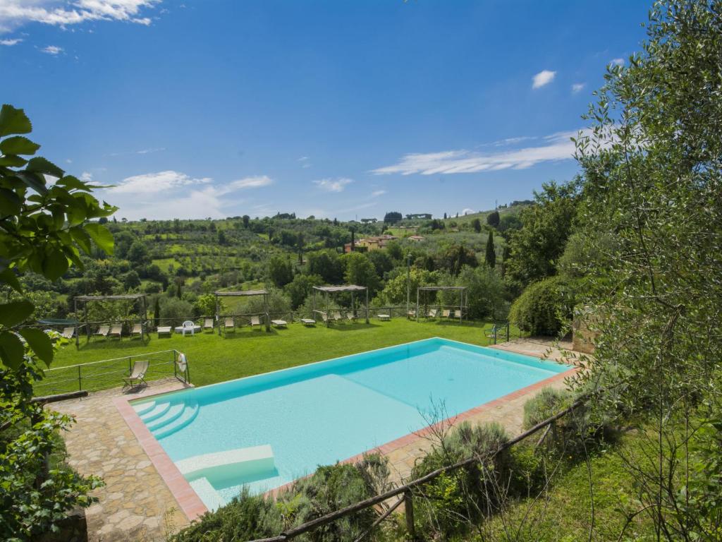 an image of a swimming pool in a garden at Apartment L'Angolo by Interhome in Grassina