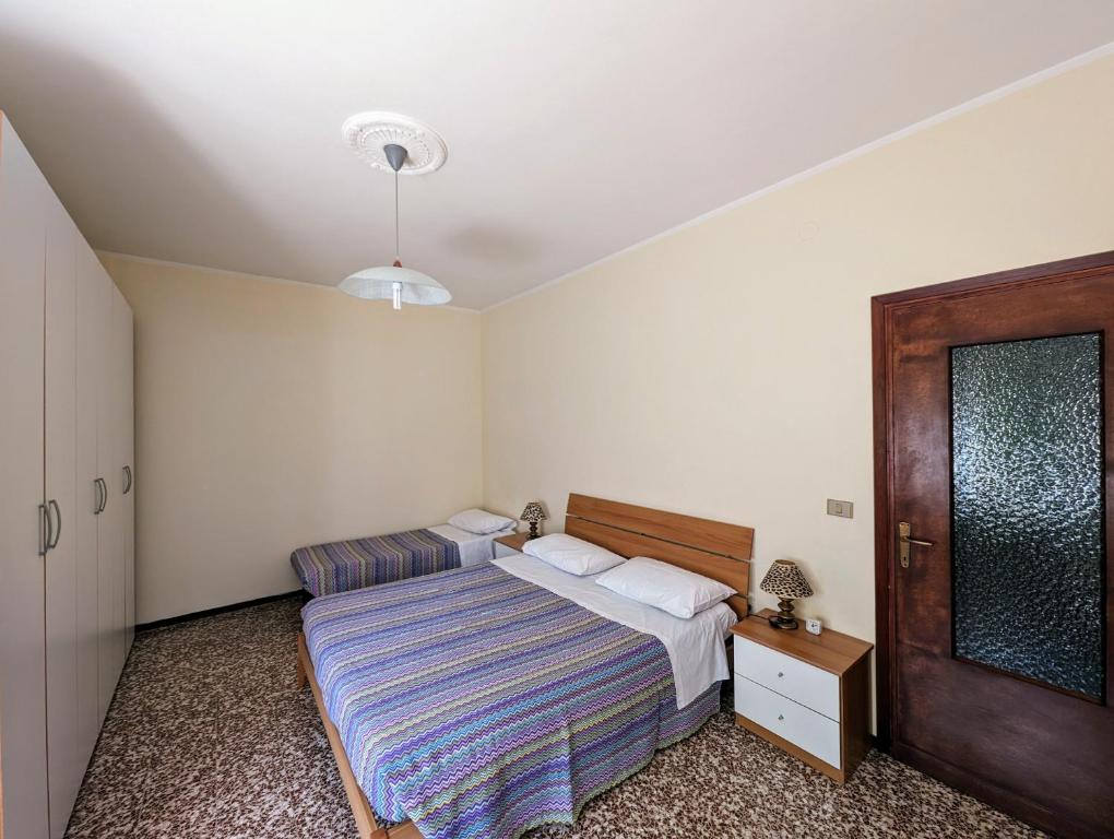 Ένα ή περισσότερα κρεβάτια σε δωμάτιο στο Residenza Parco dei Tigli