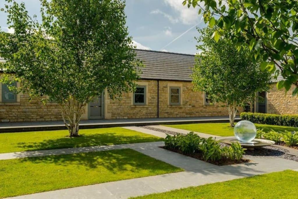 a garden with a large glass ball in front of a building at Discovery - Luxury Cosy Country Escape in Grantham
