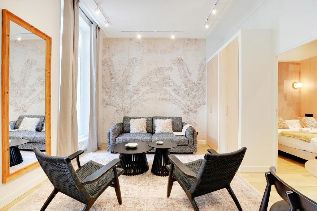un salon avec un canapé, une table et des chaises dans l'établissement Vivez une expérience au coeur de la vie parisienne, à Paris
