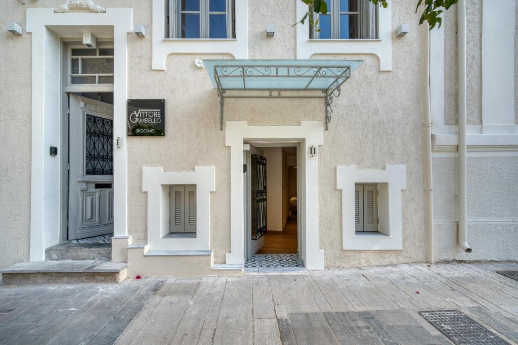 an entrance to a building with white doors at Vittore Gambello Rooms in Nafplio