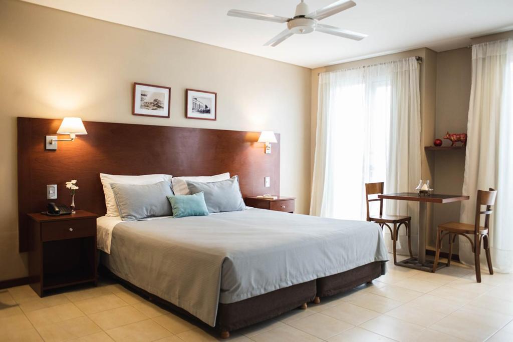 a bedroom with a large bed with a ceiling at DonSuites in Corrientes