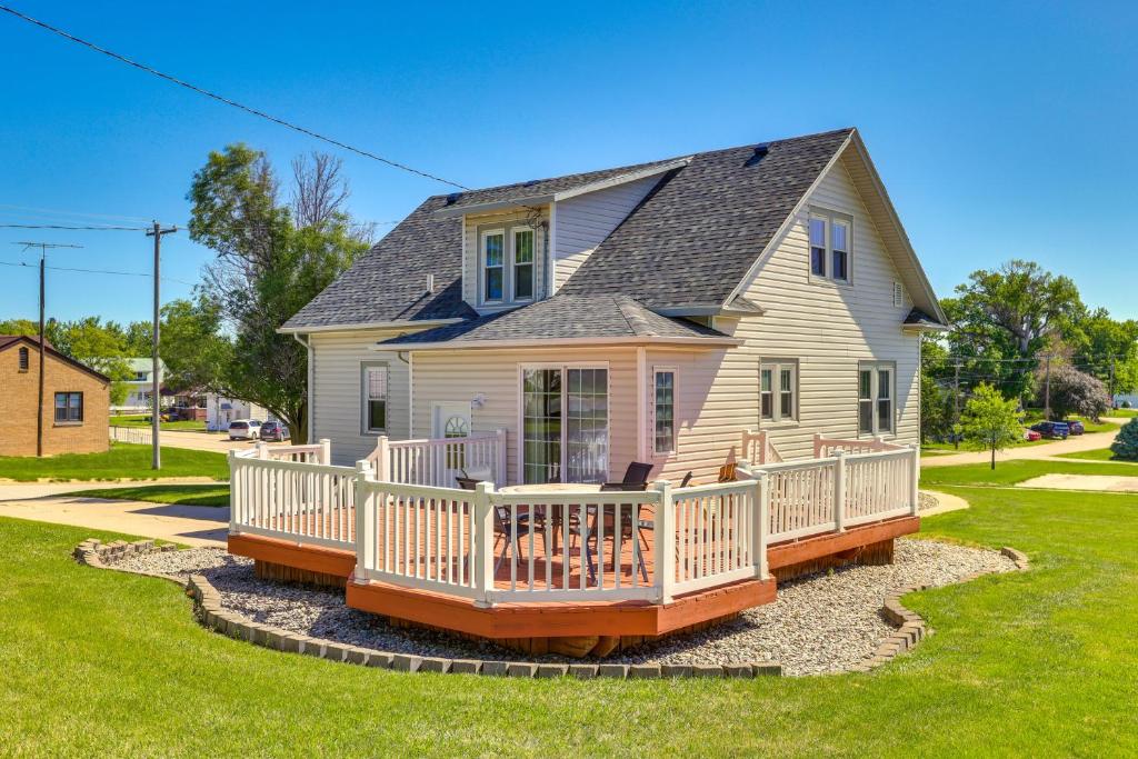 a house with a large deck on a yard at Quaint Howells Retreat - Steps from Main Street! in Howells