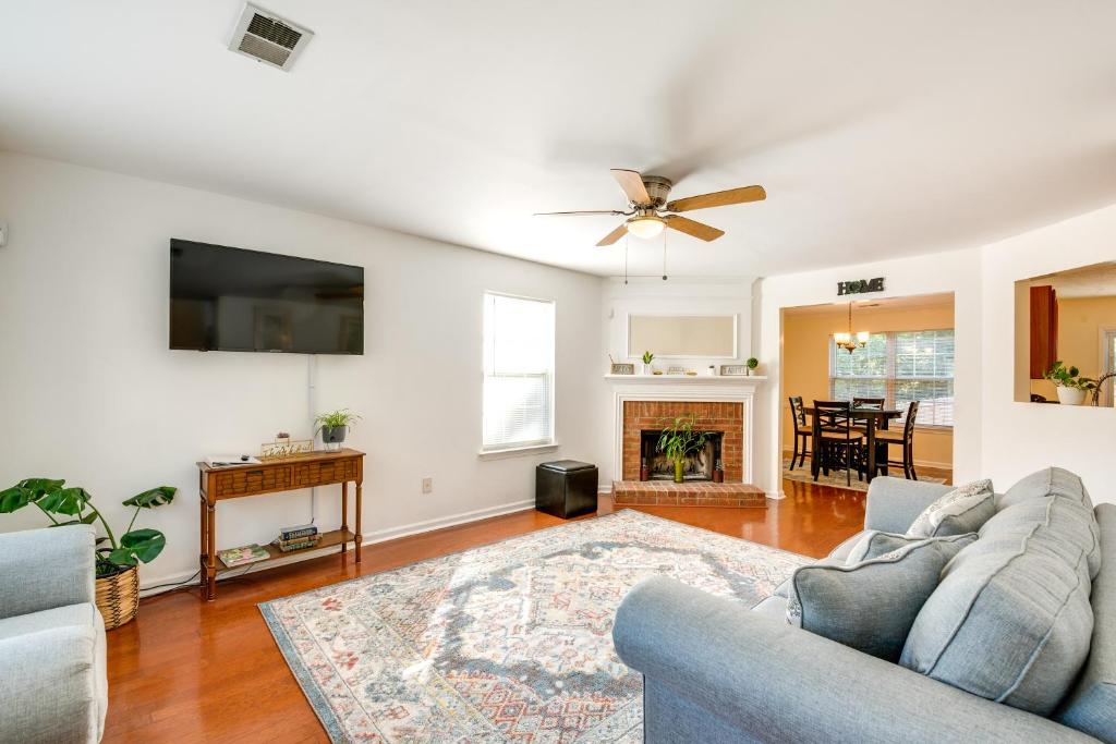 a living room with a couch and a ceiling fan at Atlanta-Area Home with Yard about 2 Mi to Six Flags in Austell