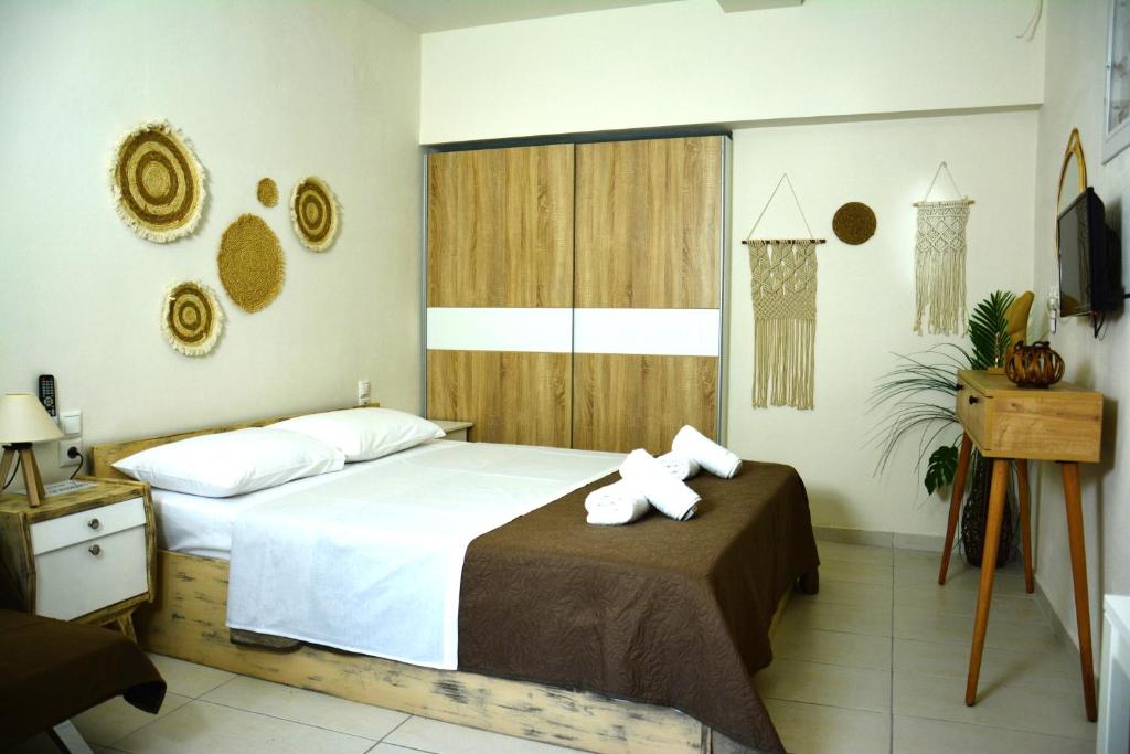 a bedroom with a bed with a bow on it at Cinque Stelle Apartments in Glífa