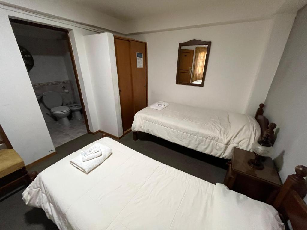 A bed or beds in a room at Apart Hotel Libertador