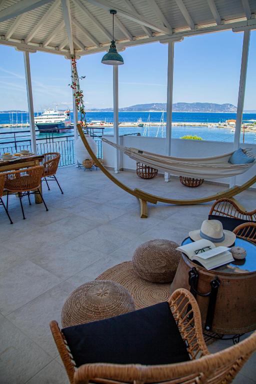 a porch with a hammock and a view of the ocean at Lalaros Apartment in Glossa