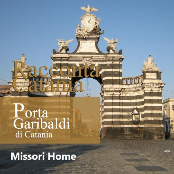 a building with a clock on top of it at Missori home 1 in Catania