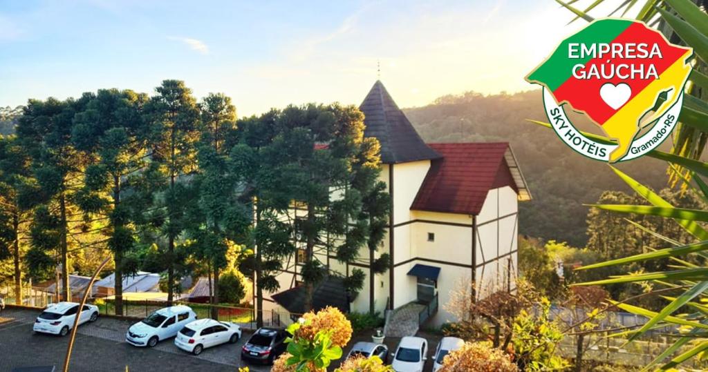 a church with cars parked in a parking lot at Sky Valle Hotel in Gramado