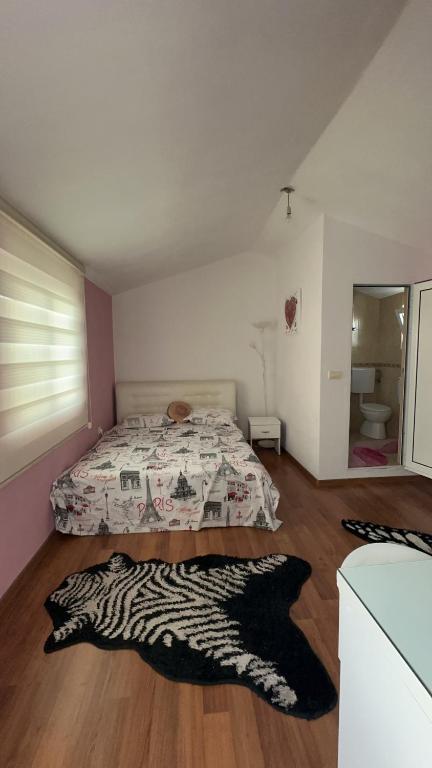 a bedroom with a bed and a zebra print rug at Sea in Ulcinj