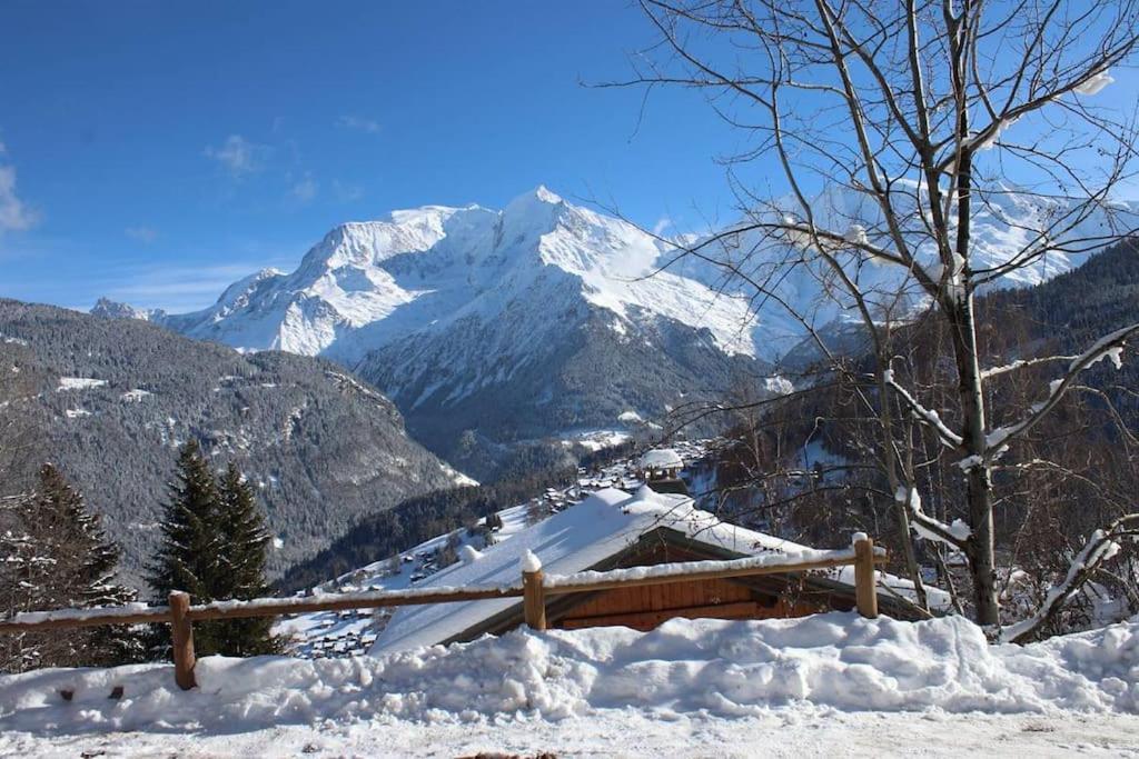 une montagne enneigée au loin avec une clôture en bois dans l'établissement Le Mazot des Tacounets, à Saint-Gervais-les-Bains