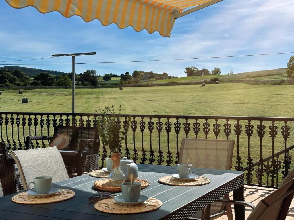 a table on a balcony with a view of a field at El Trocador - 12805 in Ajo