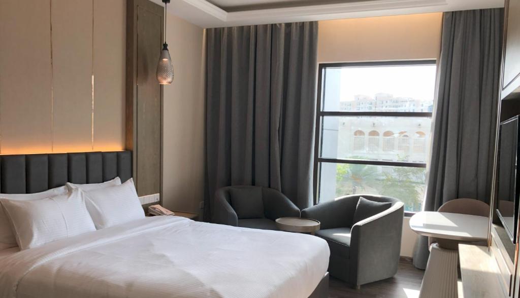 Postel nebo postele na pokoji v ubytování Frankincense Hotel Muscat فندق اللبان مسقط
