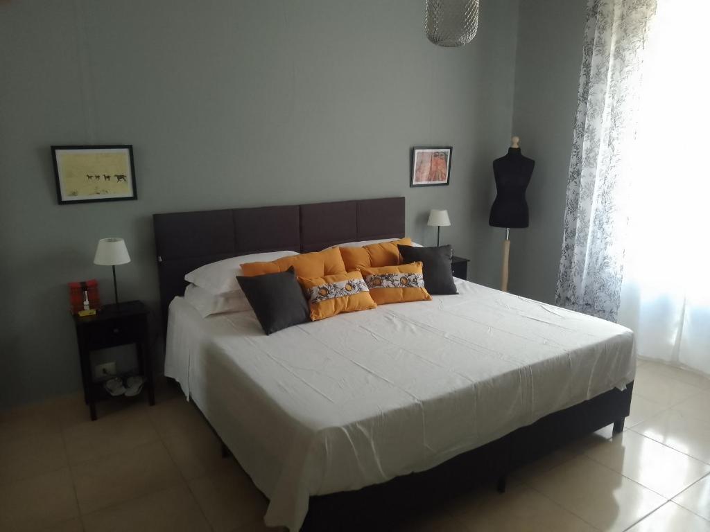 a bedroom with a large bed with many pillows at Testaccio Bodoni apartment in Rome