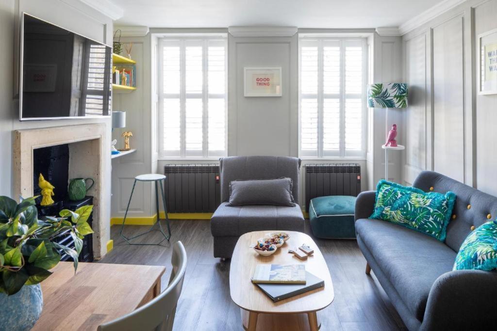 a living room with two couches and a table at Dream Stays Bath - Kingsmead Street in Bath