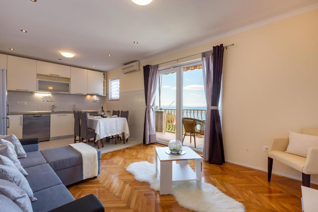 a living room with a couch and a table at Apartment Maya in Podstrana