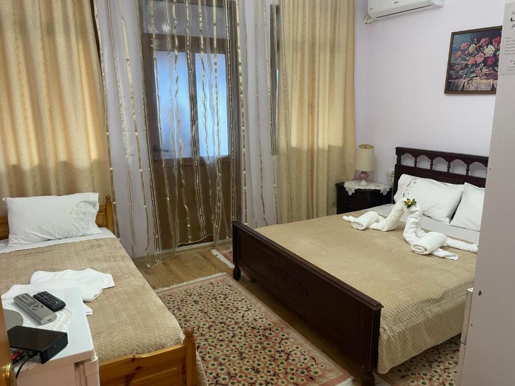 Postel nebo postele na pokoji v ubytování Luigi Guest House