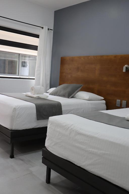 Postel nebo postele na pokoji v ubytování Hotel Riviera
