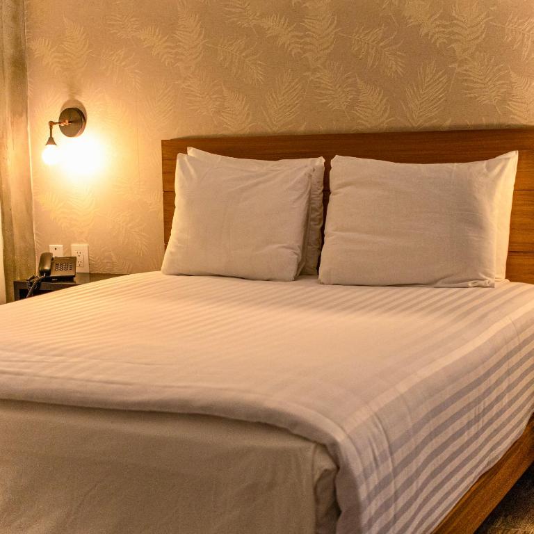 Gulta vai gultas numurā naktsmītnē Casa Bruna Luxury Lofts