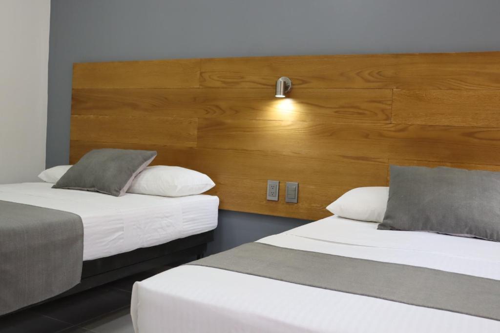 Postel nebo postele na pokoji v ubytování Hotel Riviera