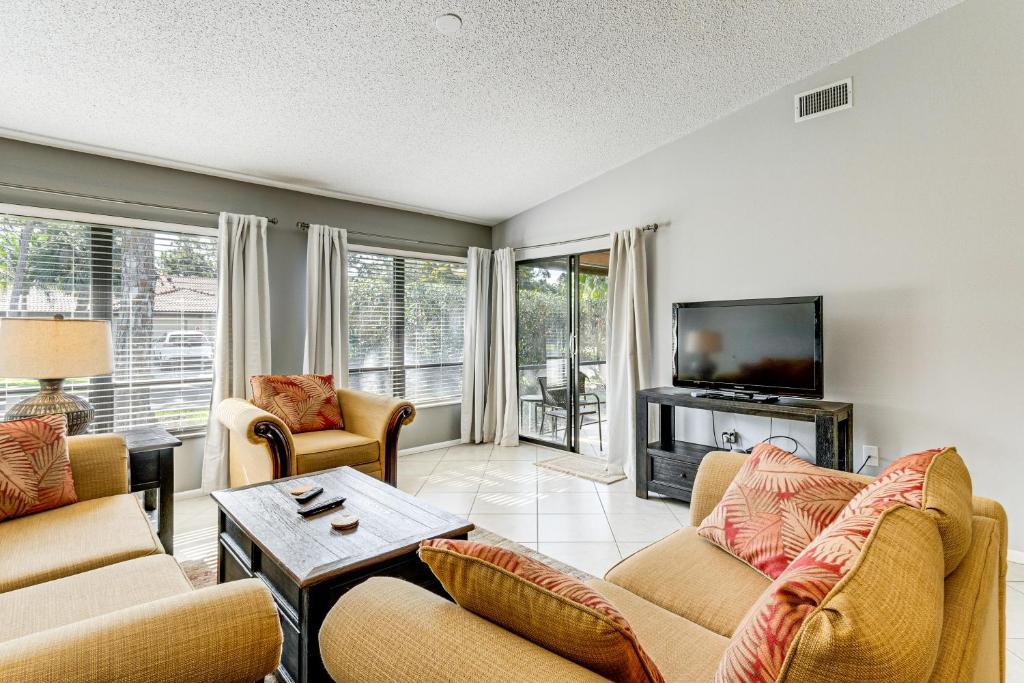 a living room with two couches and a tv at Sarasota Villa with Pool Access about 4 Mi to Beach! in Sarasota