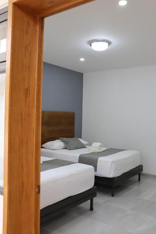Postel nebo postele na pokoji v ubytování Hotel Riviera