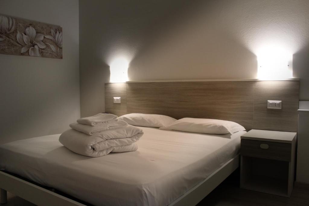 帕爾馬諾瓦的住宿－Hotel Roma，一间卧室配有带毛巾的床