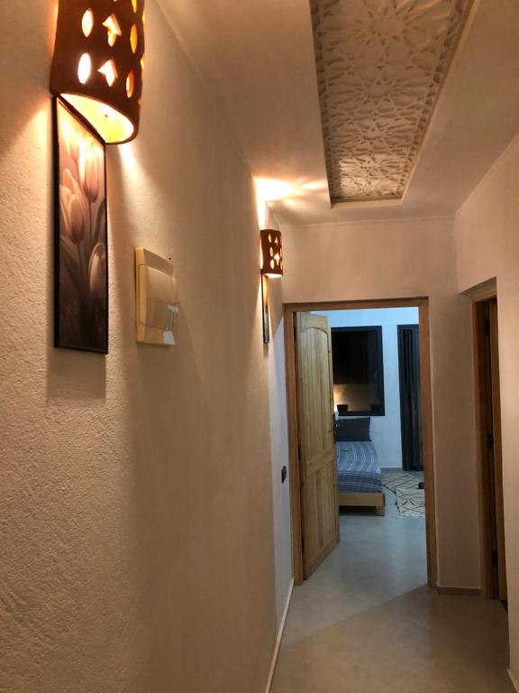 a room with a hallway with a light and a door at apartment vue Mer in Agadir