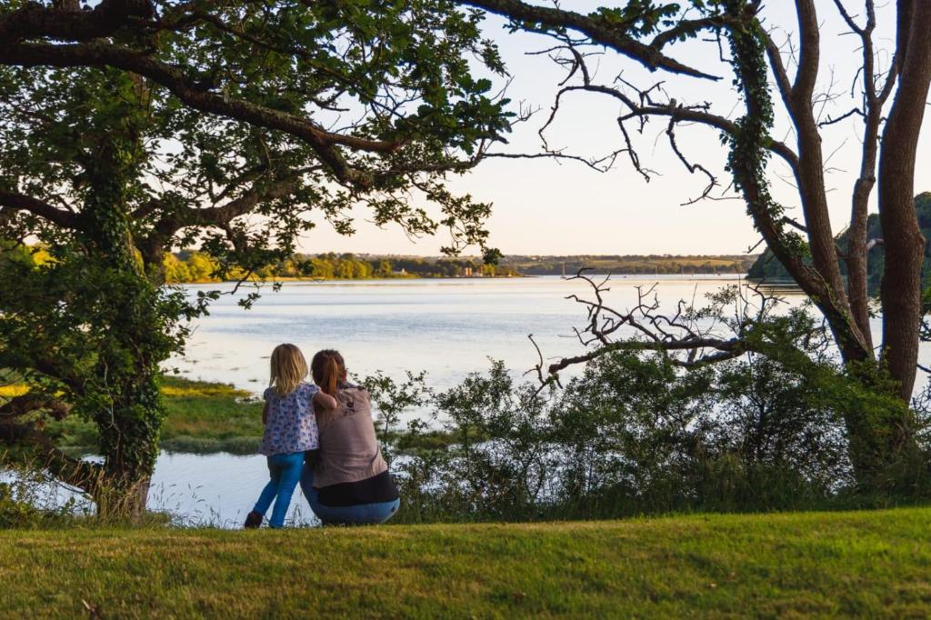 uma mulher e uma menina ao lado de um lago em Broomhill Barns em Minwear