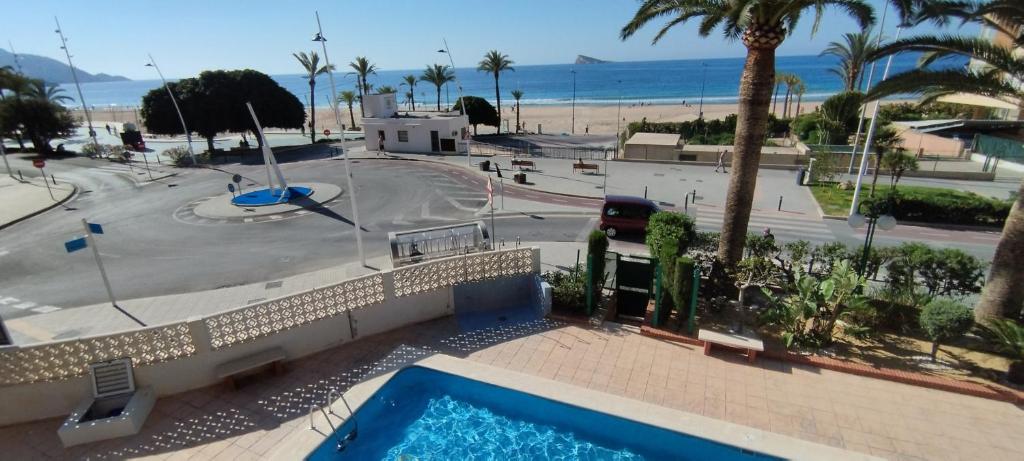 a view of a swimming pool and the beach at Principado Marina Benidorm Playa Poniente in Benidorm